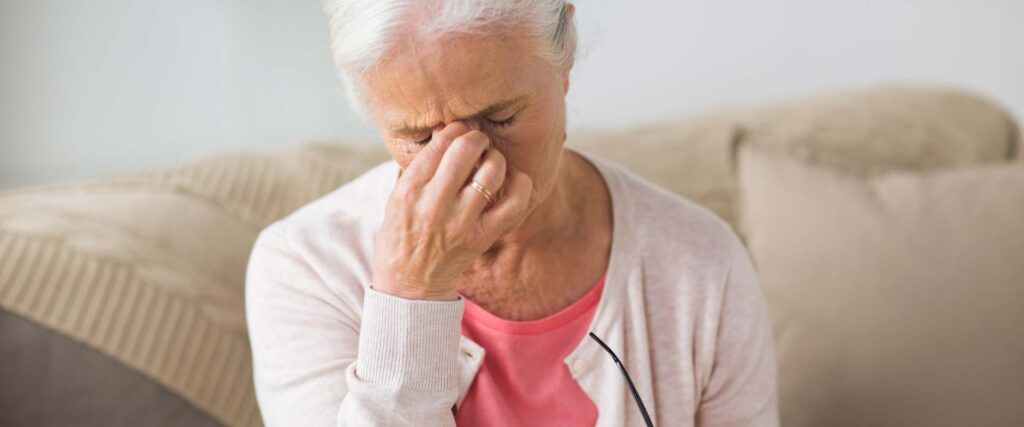 an elderly lady looking uncomfortable