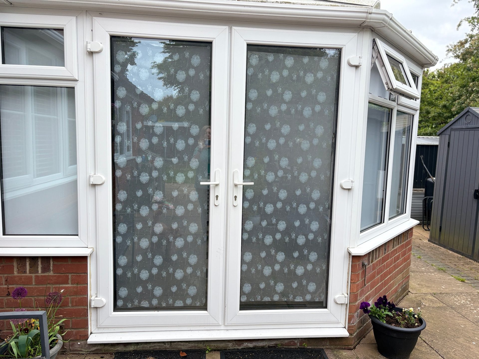 Private garden entrance with patterned glass doors leading to Katrina Hughes’ hypnotherapy room in Braintree.